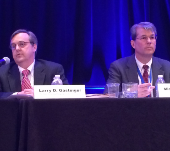 FERC's Larry Gasteiger answers questions about FERC enforcement as Michael Spofford of Bingham McCutchen (R) listens at an Energy Bar Association panel discussion in April.