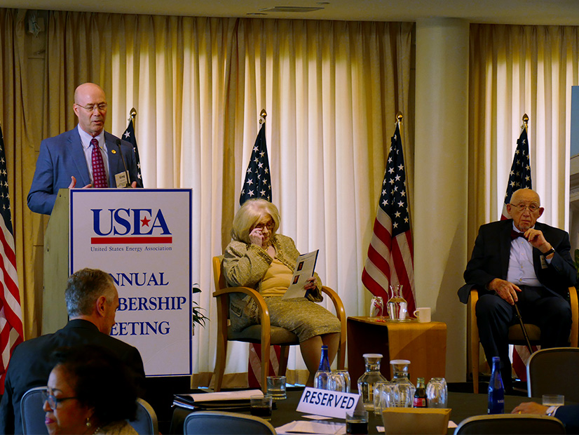 NARUC Executive Director Greg White addressing the USEA meeting with its acting Executive Director Sheila Hollis and White House Chronicle's Llewellyn King to his right