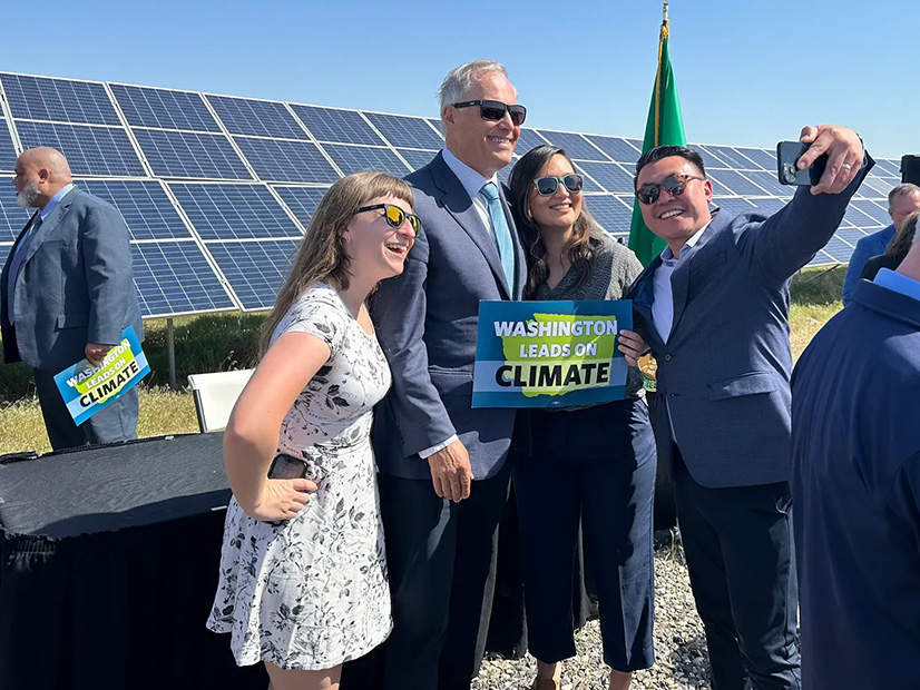 Sen. Joe Nguyễn takes a selfie with Gov. Jay Inslee, Leah Missik from Climate Solutions and Jamie Stroble from The Nature Conservancy at the bill signing ceremony in Richland, Wash.