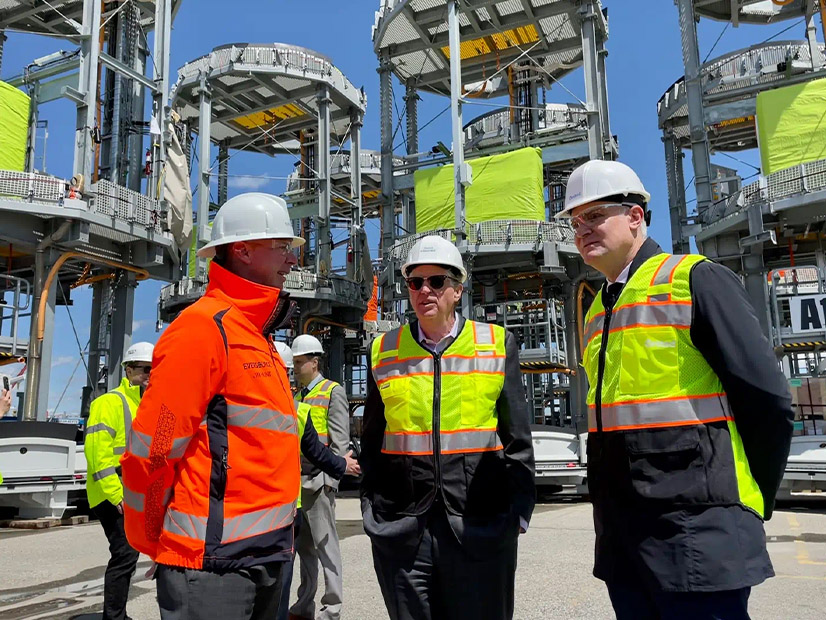 Officials tour the offshore wind power hub in Providence, R.I., that is supplying projects developed by Orsted and Eversource.