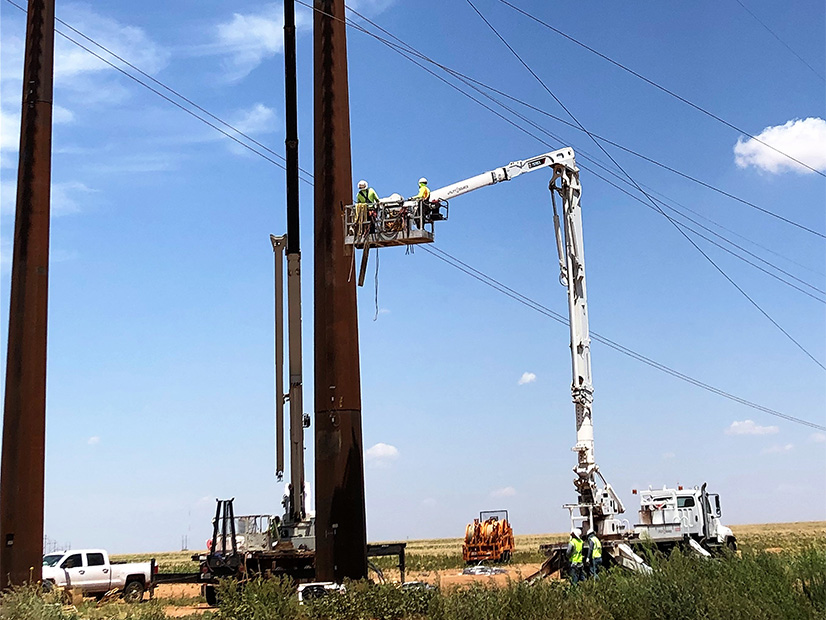 Line crew works on an Xcel Energy transmission line.