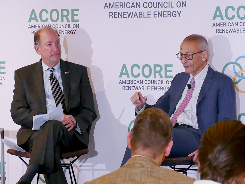 White House official John Podesta (right) talks with ACORE President Gregory Wetstone
