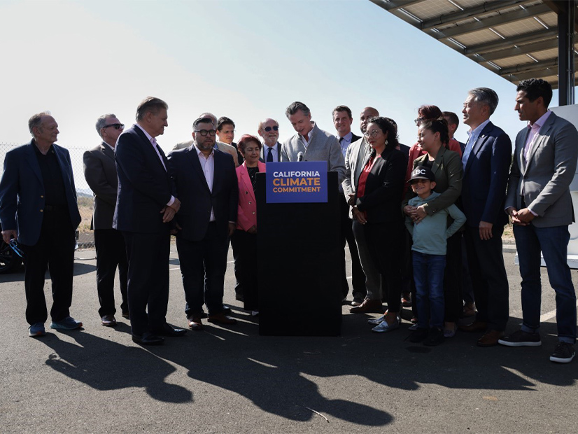 Surrounded by lawmakers, Gov. Gavin Newsom signed climate and energy legislation in September.