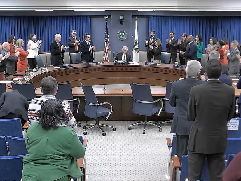 FERC Chair Richard Glick receives a standing ovation at the close of his final commission meeting.