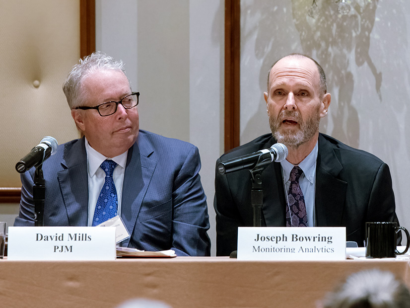 Joseph Bowring (right), president of Monitoring Analytics, speaks during the Organization of PJM States annual Market Monitoring Advisory Committee meeting on Oct. 18 while David Mills, PJM listens.