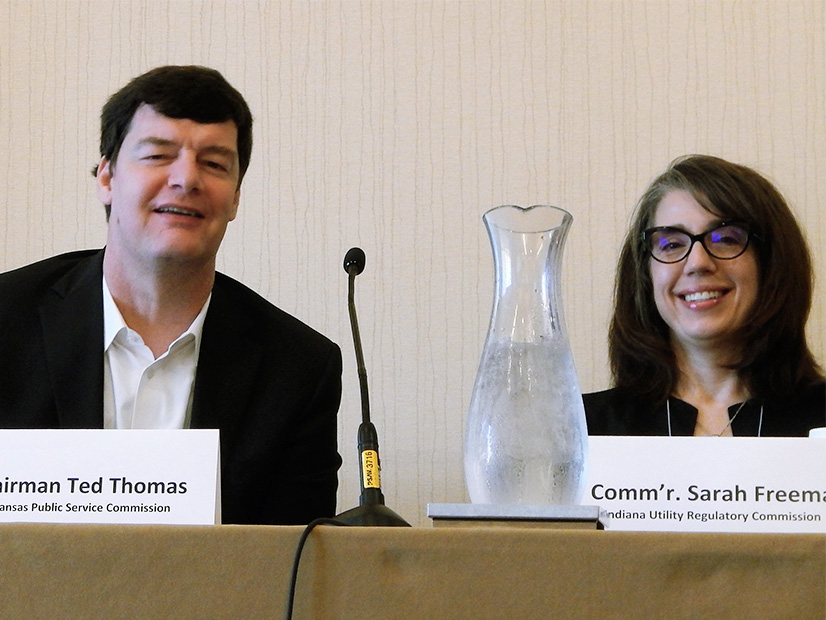 Ted Thomas shares a laugh with fellow commissioner Sarah Freeman (Indiana) during a 2019 panel discussion.
