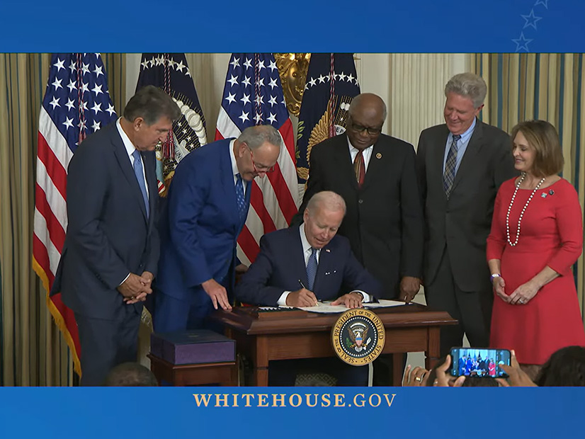 At the White House, (from left) Sen. Joe Manchin, Senate Majority Leader Chuck Schumer, Rep. Jim Clyburn, Rep. Frank Pallone and Rep. Kathy Castor look on as President Joe Biden signs the Inflation Reduction Act on Tuesday.