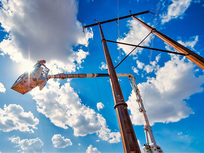 A Xcel Energy lineman at transmission tower.