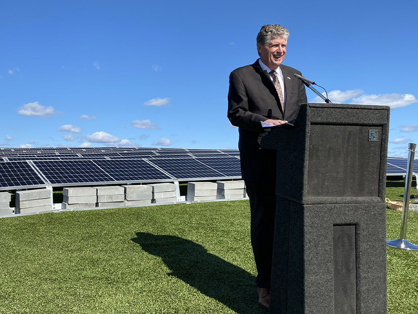 Environmental advocates expect Rhode Island Gov. Dan McKee, seen here at a ribbon cutting for a solar project in Cranston last year, to sign a bill that will increase the state's Renewable Energy Standard to 100% by 2033.