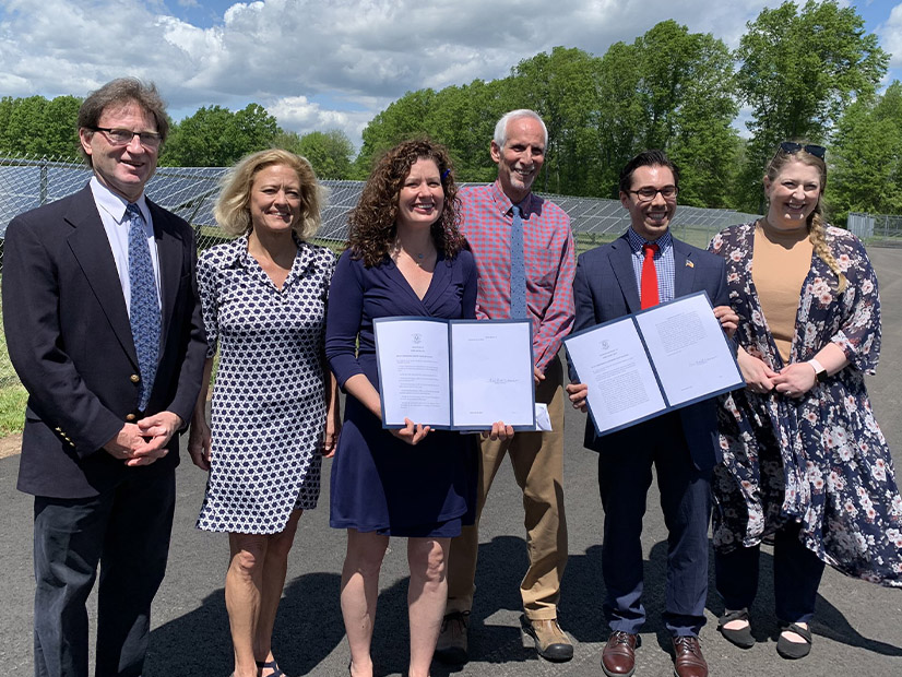 Connecticut DEEP Commissioner Katie Dykes (center left) joins state leaders to celebrate the signing of a bill in May codifying 100% zero-carbon electricity by 2040, a legislative priority of the Governor's Council on Climate Change.