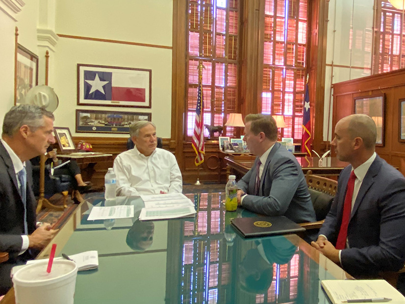 Texas Gov. Greg Abbott (center) meets with ERCOT CEO Brad Jones (left) and Texas PUC Chair Peter Lake (Abbott's left) Friday to discuss grid conditions.