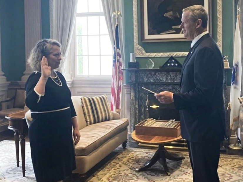 Gov. Charlie Baker swears in Beth Card as the new Energy and Environmental Affairs Secretary for Massachusetts.
