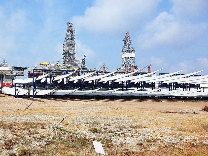 Wind blades sit after being unloaded from a ship on the Gulf Coast, soon to add to ERCOT's wind power.