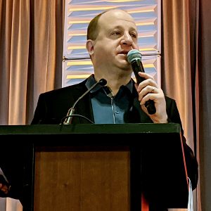 Gov. Jared Polis speaks at COSSA's Solar Power and Energy Storage Mountain West Conference.