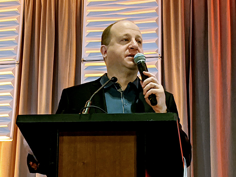 Gov. Jared Polis speaks at COSSA's Solar Power and Energy Storage Mountain West Conference.