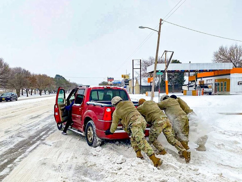 Members of the Texas National Guard assist a motorist stuck in the ice during February's extreme winter conditions in Abilene, Texas.