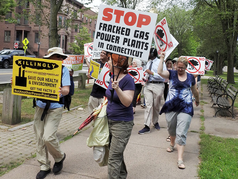 Environmental activists marched in August 2019 at the headquarters of the Connecticut Department of Energy and Environmental Protection in Hartford to protest the approval of a 650-MW power plant in Killingly, Conn.