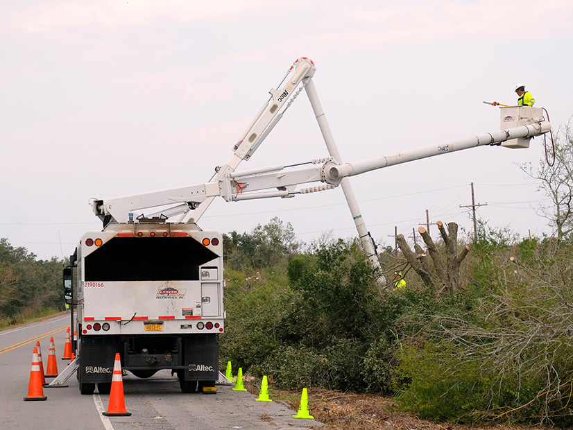 Entergy crews work to restore power in New Orleans. The utility said Monday that more than half of the 902,000 customers who lost power in Louisiana following Hurricane Ida had been restored.