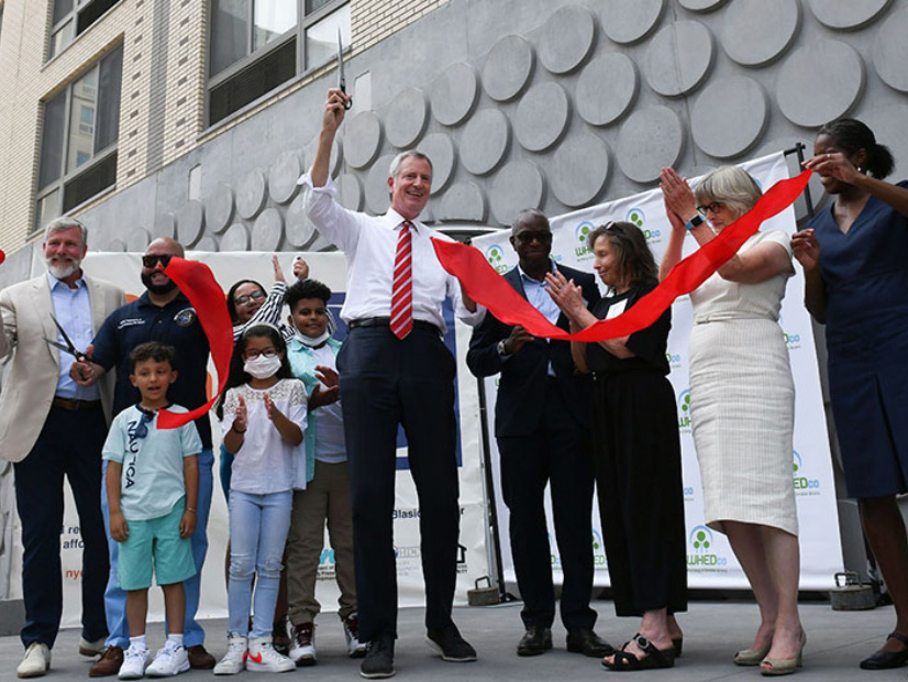 NYC Mayor Bill de Blasio, seen here celebrating new affordable housing in July, said the city...s partnership with NYSERDA will help decarbonize older buildings.