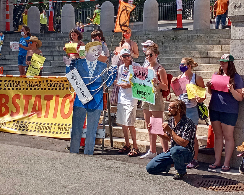 Massachusetts activists with the Sunrise Movement, Breathe Clean North Shore and more protested the state's continued funding of fossil fuel activities, such as a new natural gas plant in Peabody, at a rally outside of the state house on Saturday.