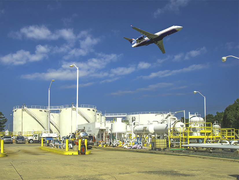 <p>A jet flies over a fuel storage facility operated by Colonial Pipeline. The ransomware attack against Colonial in May resulted in the weeklong shutdown of the company's entire pipeline network, disrupting fuel supplies across the U.S. East Coast.</p>