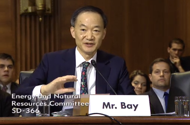Norman Bay, with Richard Gates looking on, responds to questions during his Senate confirmation hearing in May.