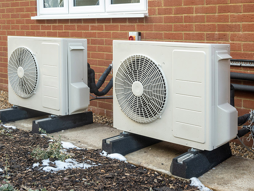 Air-source heat pumps are shown outside a home.