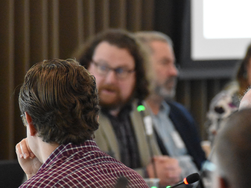 BPA's Russ Mantifel (background, center) speaks during a June Markets+ meeting.