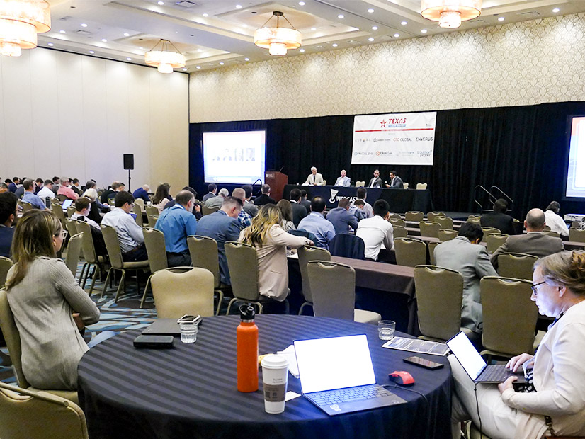 Attendees take notes during the Infocast Clean Energy Summit. 