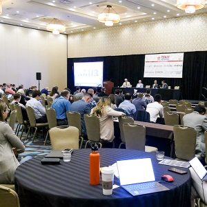 Attendees take notes during the Infocast Clean Energy Summit. 