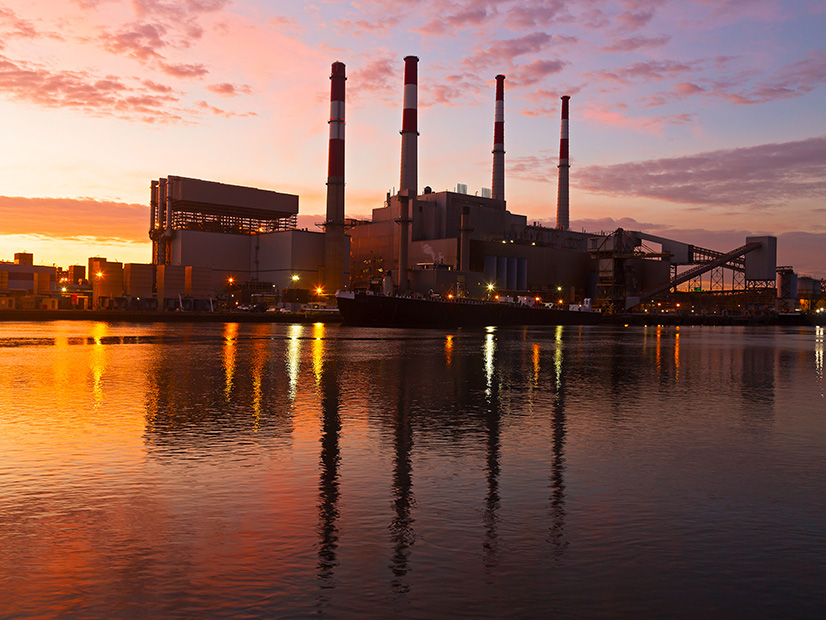 An electric power plant is shown at sunrise in New York City.