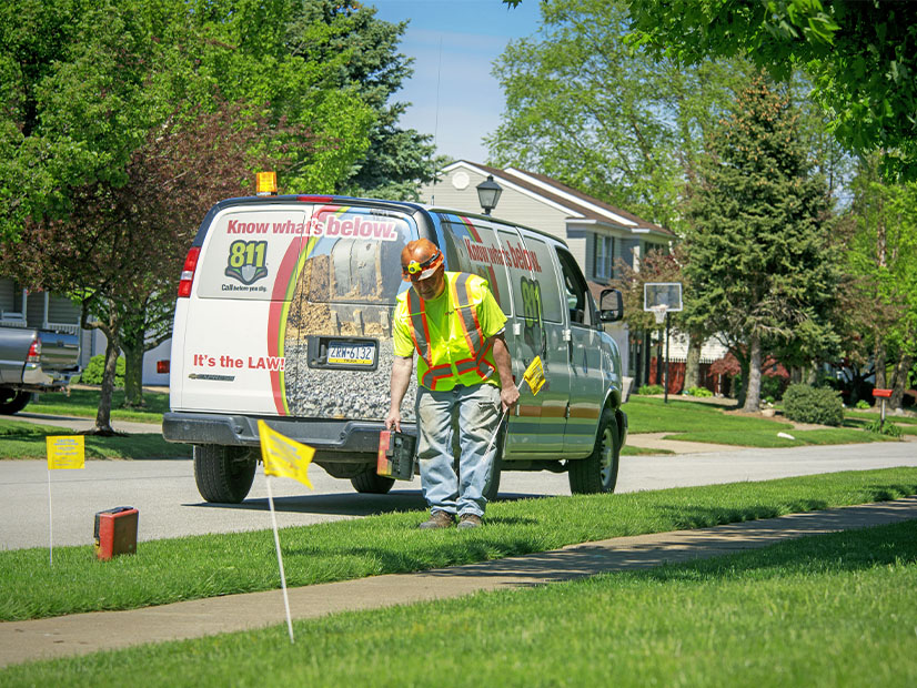 A National Fuel Gas employee marks underground gas lines for safety.