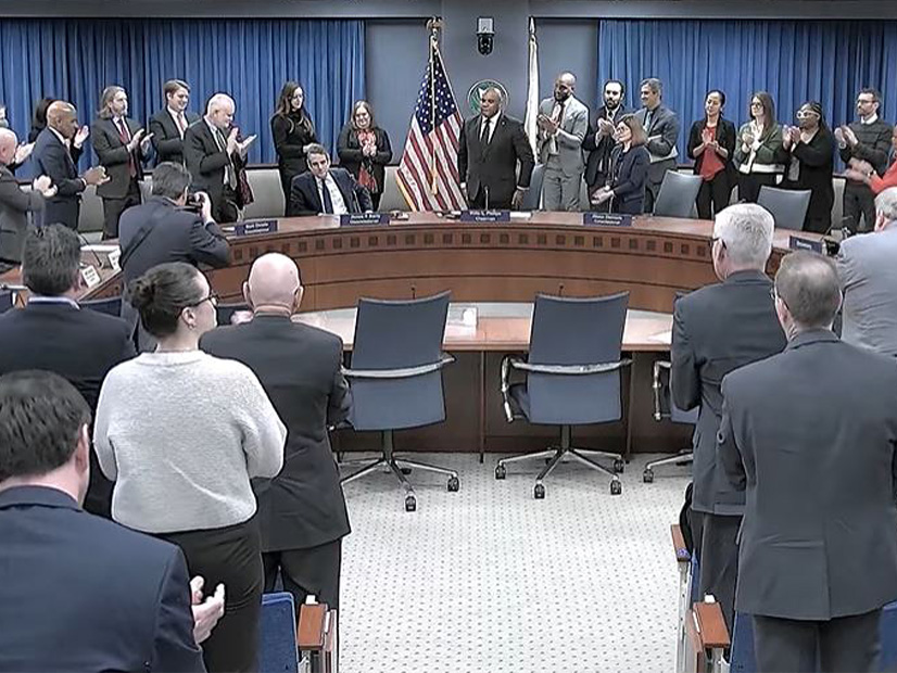 Commissioner James Danly gets a standing ovation at the open meeting.