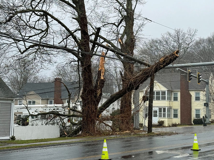 An Eversource crew responds to a downed tree and broken pole in Meriden, Conn., during Monday's storm.