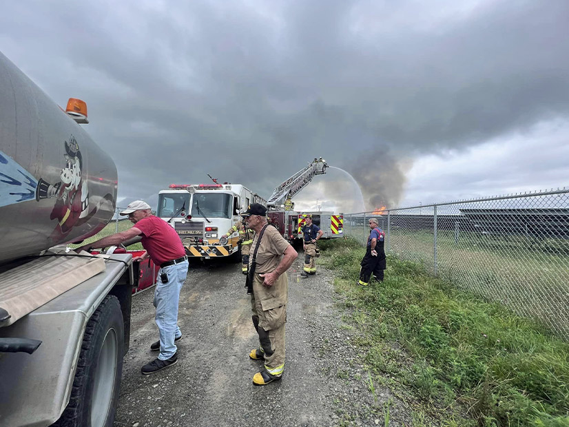 Firefighters pour water on a large fire at a solar and battery facility in northern New York in July 2023.