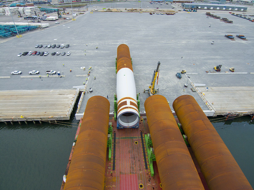 The first monopile foundations for the Coastal Virginia Offshore Wind project are unloaded in Portsmouth in October 2023.