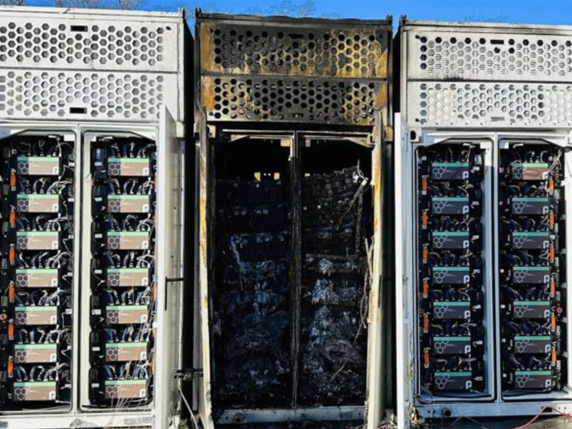 A rack of batteries after a UL 9540a unit fire test, with the middle unit burned out.