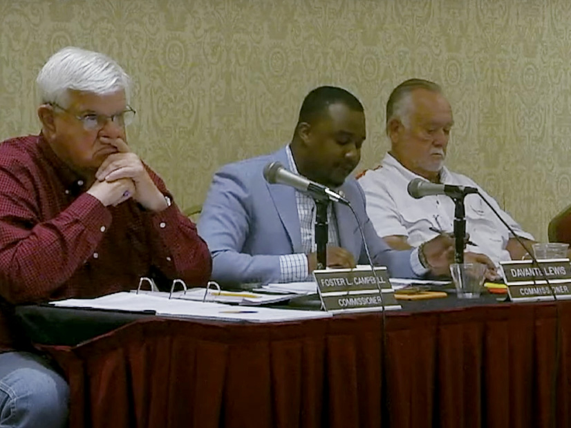 Commissioner Davante Lewis (middle) speaks against Entergy's grid resilience plan at an April 19 meeting.