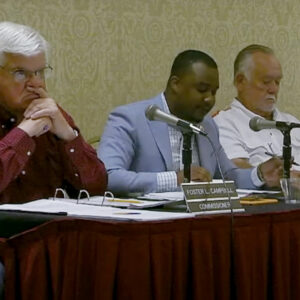 Commissioner Davante Lewis (center) speaks against Entergy's grid resilience plan at an April 19 meeting.