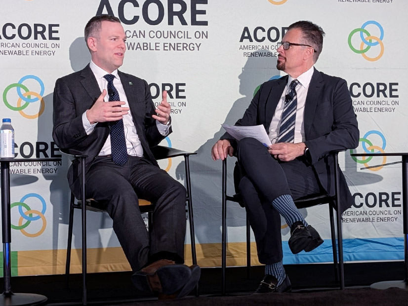 FERC Commissioner David Rosner on stage with ACORE CEO Ray Long at a grid forum.