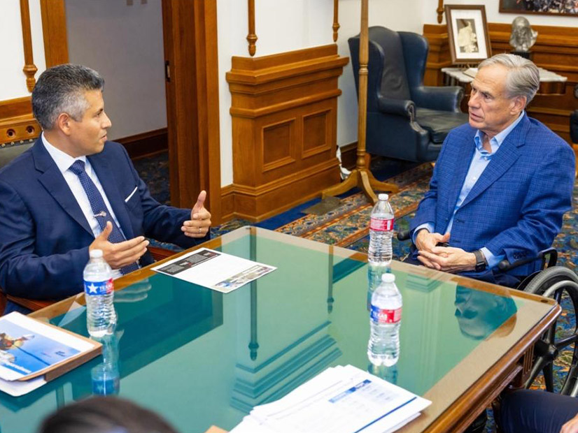 Entergy Texas CEO Eliecer Viamontes discusses the utility's power plant proposal with Texas Gov. Greg Abbott in 2024.