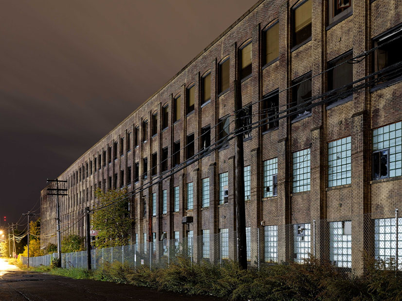 A fire-damaged industrial complex in Utica, N.Y., is shown in 2021, before demolition. A subsequent effort to repurpose 12 acres of the site for a 20-MW battery energy storage system was abandoned as not economically viable.