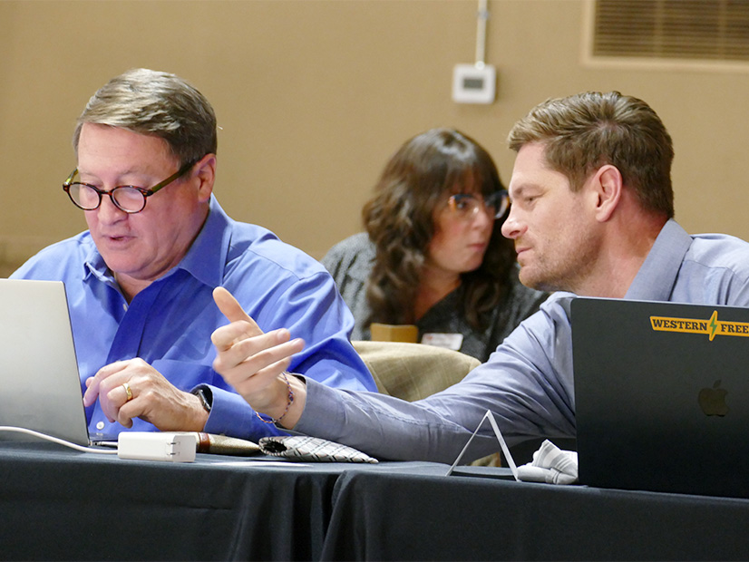 Western Power Trading Forum's Scott Miller (left) and Western Freedom's Andrew Sand confer during the November MPEC meeting.
