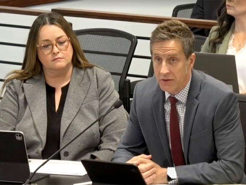 Kerri Carnes, left, and Jeff Allmon of APS address the Arizona Corporation Commission on Dec. 3.